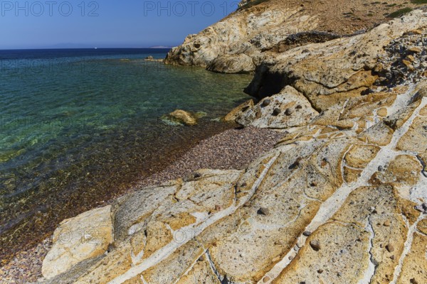 Rugged coastline with clear blue waters and sunlit rocks, Lambi Beach, Lambi Bay, Patmos, Dodecanese, Greek Islands, Greece