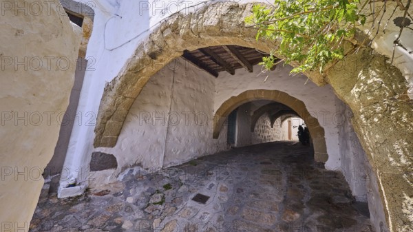 Old stone alleyway with arches and shade, offering a historic and cosy atmosphere, Chora, UNESCO World Heritage Site 1999, Patmos, Dodecanese, Greek Islands, Greece