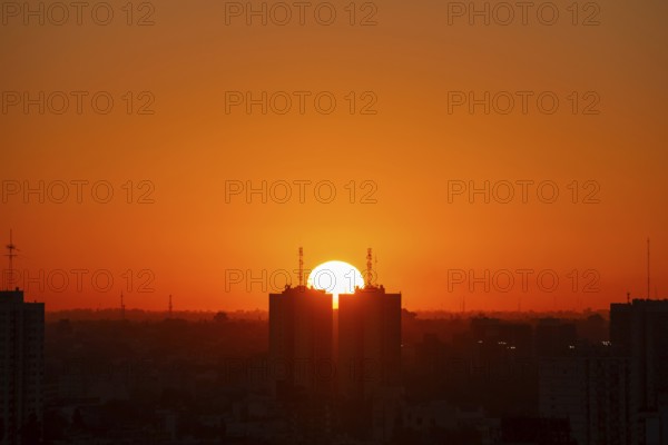 Sunset over skyscrapers in Buenos Aires, symmetry in photography, symbolic image for heat, global warming, climate change, environmental problems, Buenos Aires, Argentina