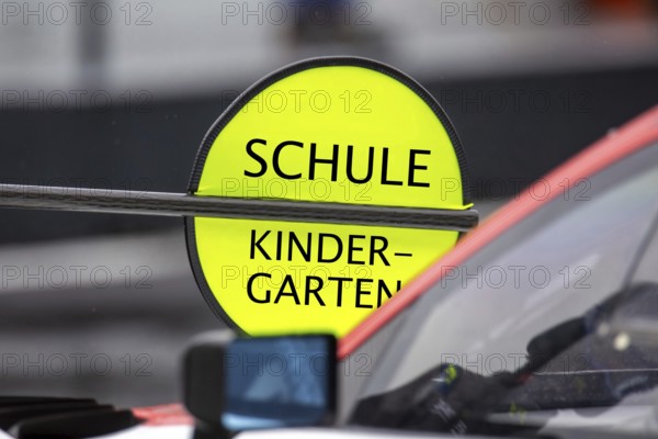 (Photomontage) Kindergarten/School Symbol image: Lollipop in motorsport with modified text KINDERGARTEN / SCHOOL