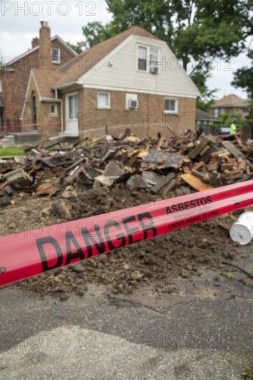 Detroit, Michigan - Signs warn of asbestos danger where a house was demolished. The house had been heavily damaged by fire a year earlier and was a neighborhood eyesore