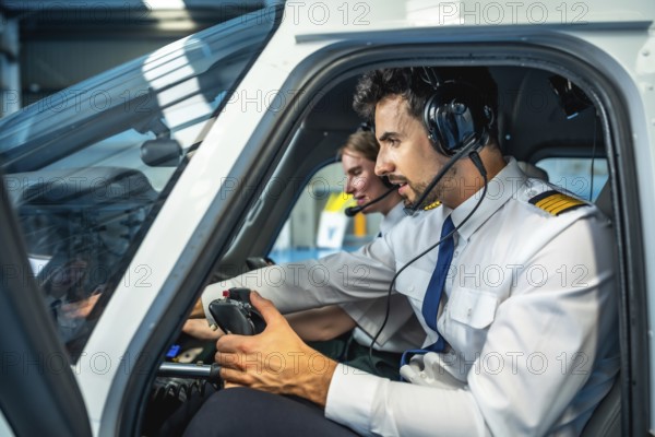 Two male pilots are sitting in the cockpit of a flight simulator, using headsets and holding controls, engaged in training
