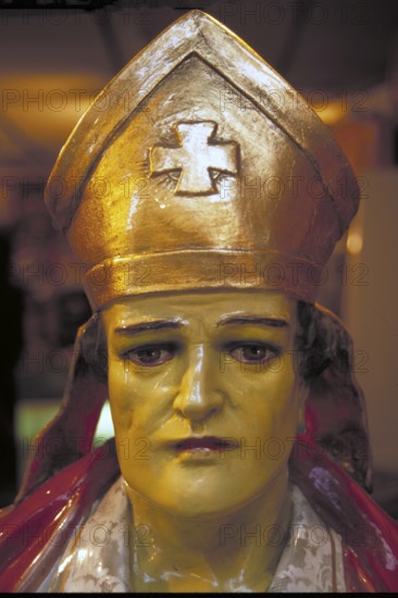 Figure of a saint in a shop window, New York City, USA