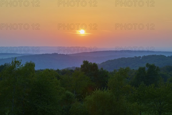 Sunset with red tones over hills and trees, quiet evening landscape, Geishöhe, Dammbach, Spessart, Bavaria, Germany