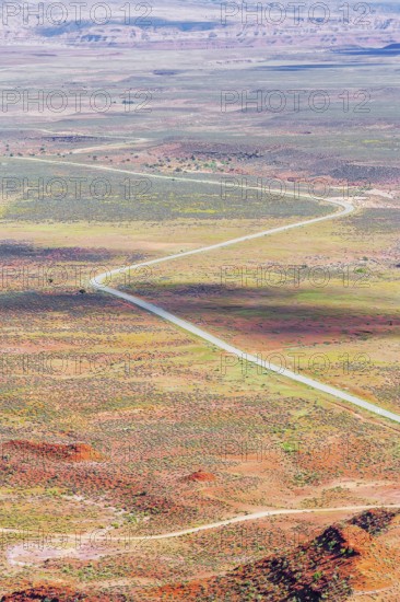 Winding roadway cutting through Valley of the Gods, Utah, USA