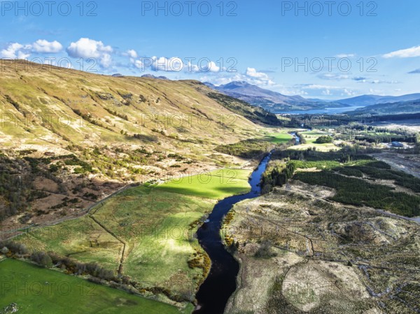 Farms and Mountains over River Dochart and Road A85 from a drone, Perthshire, Scotland, UK