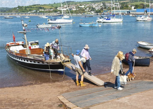 Shaldon ferry arriving, small boats in harbour at Back Beach, Teignmouth, south Devon, England, UK