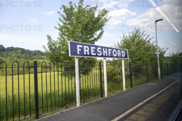 Freshford railway station platform sign taken through train window, Somerset, England, UK