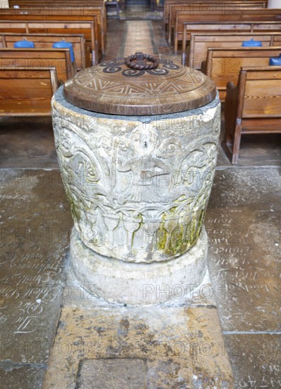 Historic baptismal font inside village parish church of Saint James, Avebury, Wiltshire, England, UK