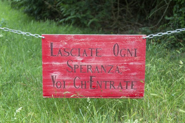 Lasciate Ogni Speranza Voi Ch'Entrate sign on chain, Suffolk, England, UK - abandon all hope, ye who enter