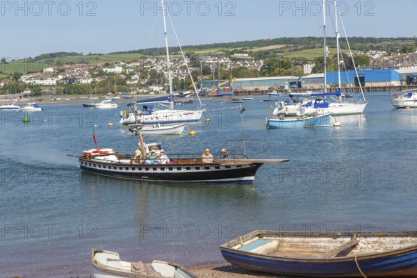 Shaldon ferry arriving, small boats in harbour at Back Beach, Teignmouth, south Devon, England, UK