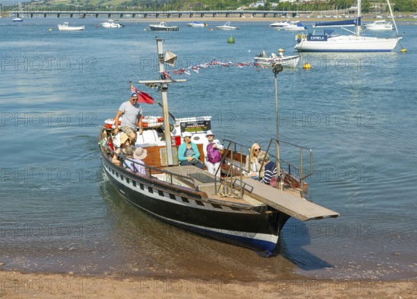 Shaldon ferry arriving, small boats in harbour at Back Beach, Teignmouth, south Devon, England, UK