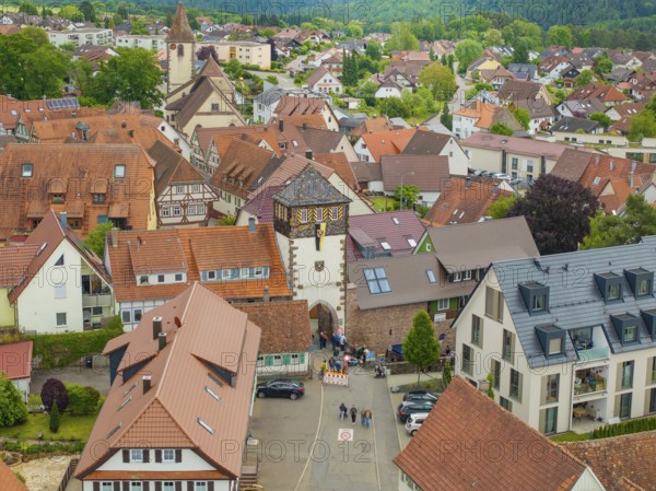 View of a picturesque village with half-timbered houses and a church, surrounded by green countryside, family party in Neubulach, district of Calw, Germany