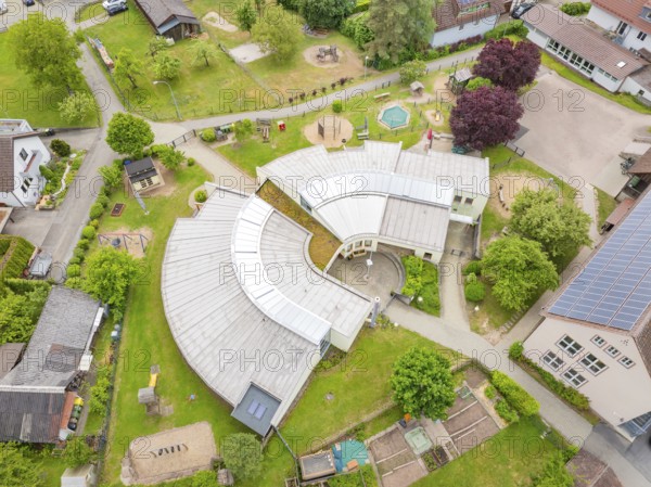 Bird's eye view of modern-style building complex with surrounding green and play areas, family party in Neubulach, Calw district, Germany