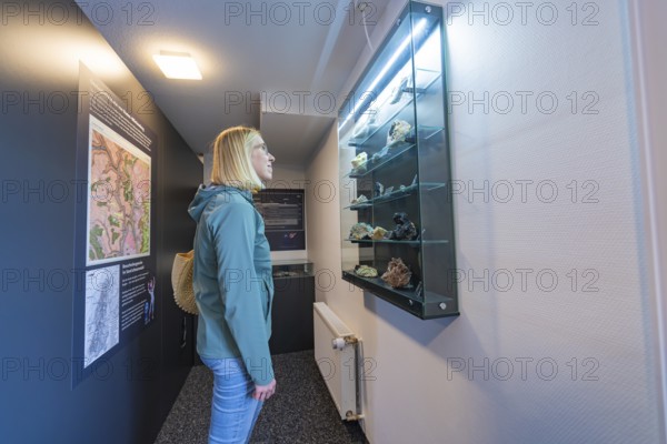 Glass showcase with stones and information boards in a museum room, family festival in Neubulach, Calw district, Germany