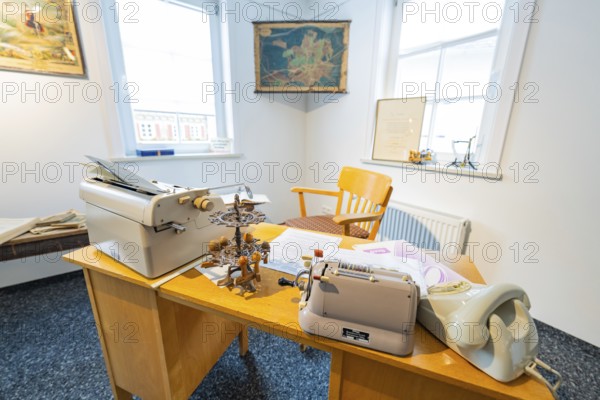 Old-fashioned office with typewriter, desk and chair, lit by daylight, family party in Neubulach, district of Calw, Germany