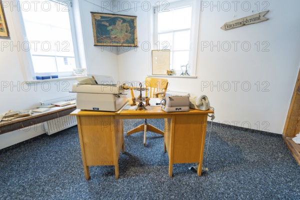 Historic office with old typewriters and telephones in a bright room, family party in Neubulach, district of Calw, Germany