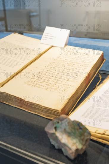 Old book with handwritten notes displayed in a showcase, Family Festival in Neubulach, Calw district, Germany