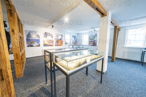 Modern room with photographs and glass showcases, stylish presentation, family celebration in Neubulach, district of Calw, Germany