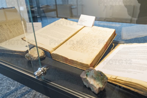 Old books with visible texts presented in a glass display case, family festival in Neubulach, district of Calw, Germany