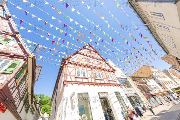 Cheerful sight of a decorated city street with colourful flags, Calw station festival, Black Forest, Germany