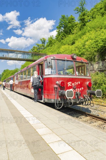 Red train on a platform on a sunny day, Calw railway station festival, Black Forest, Germany