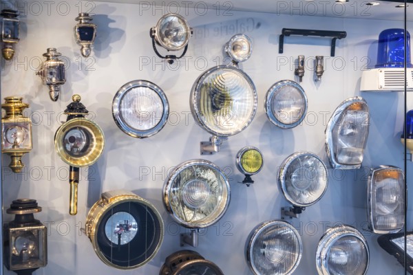 Front lighting, driving lights. The Mercedes-Benz Museum in Stuttgart presents a journey through the automotive history of the global corporation. The history of the Mercedes star begins with the first automobile in 1886. 160 vehicles are on display. Stuttgart, Baden-Württemberg, Germany