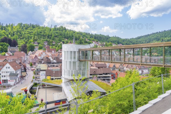Overview of a pedestrian bridge in a small town with many trees and buildings, Zob extension with bridge construction for the new Herman Hesse railway, Calw, Black Forest, Germany