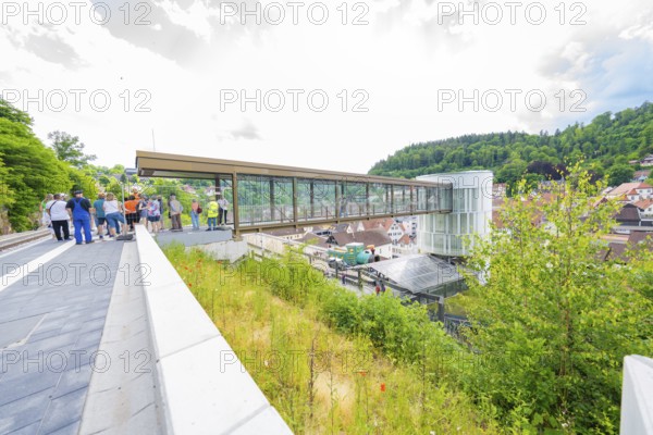 A group of people gather on a bridge overlooking a town, Zob extension with bridge construction for the new Herman Hesse railway, Calw, Black Forest, Germany