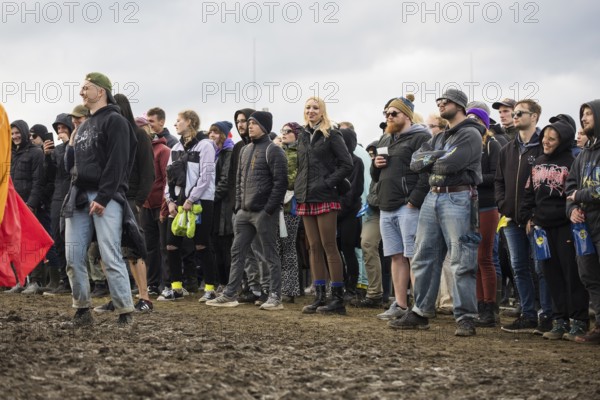 Festival-goers stand in the mud in front of the Atmos Stage at the Rock am Ring Festival on Sunday, Nürburgring race track race track, 08/06/2025