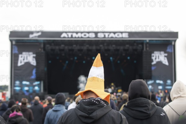 Festival visitors with a hat shaped like a cone in front of the Atmos Stage at the Rock am Ring Festival on Sunday, Nürburgring race track race track, 08.06.2025