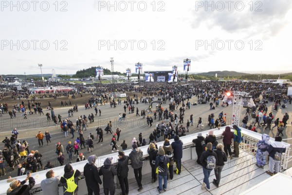 Festival-goers look at the Mandora Stage in the evening sun at the Rock am Ring Festival on Sunday, Nürburgring race track race track, 08.06.2025