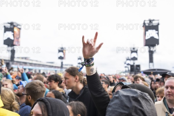 A festival visitor shows the French fries fork at the Rock am Ring Festival on Friday, Nürburgring race track race track, 07/06/2025
