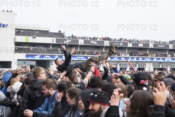 Festival visitors crowdsurfing at the Rock am Ring Festival on Friday, Nürburgring race track race track, 07/06/2025