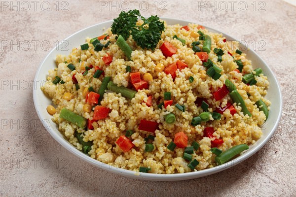 Couscous with vegetables, paprika, carrots, string beans, corn, homemade, top view, no people