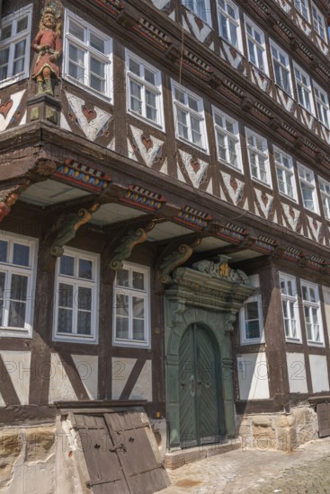 The Bürgersche Haus from 1639, symmetrical half-timbered house with attached dwarf house, Bad Sooden, Allendorf, Allendorf district, historic old town with numerous half-timbered houses under monument protection, entrance portal, cellar access, wooden figures, decorations, hearts, Werra-Meissner district, Hesse, Germany