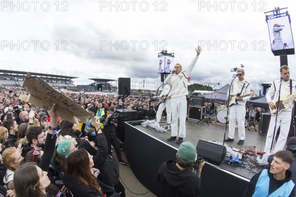 Steffen Israel (guitarist and keyboarder), Felix Brummer (singer), Karl Schumann (guitarist) and Till Brummer (bassist) of Kraftklub at a secret gig of the band at the Rock am Ring Festival on Saturday, Nürburgring race track race track, 07.06.2025 Note: the photo was taken with a fisheye lens