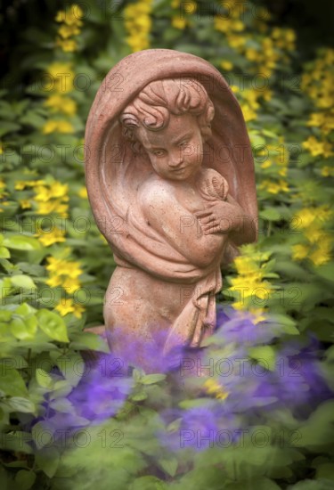 Terracotta statue, girl, between spotted loosestrife (Lysimachia punctata), also spotted loosestrife, garden, movement effect, wiping effect, Stuttgart, Baden-Württemberg, Germany