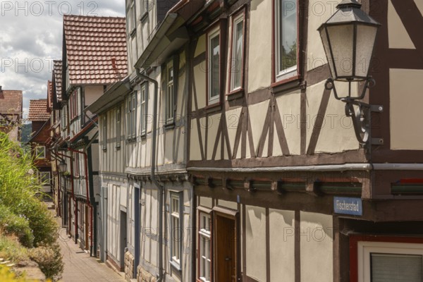 Old fishermen's settlement along the Werra, Bad Sooden, Allendorf, district Allendorf, street Fischerstad under monument protection, lettering street name, row of half-timbered houses, lantern, narrow street, Werra-Meissner-Kreis, Hesse, Germany