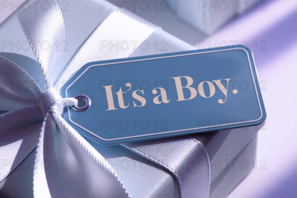 Close up of tag with text it's a boy on baby blue gift box, a commentary on gender roles and stereotypes. Generative Ai, AI generated