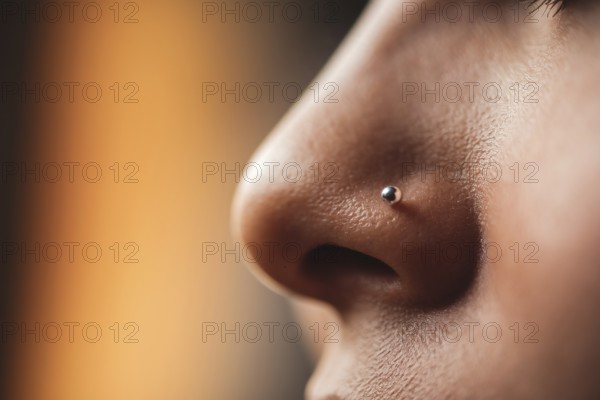 Close-up of delicate silver nose stud on female skin in warm light. Generative ai, AI generated