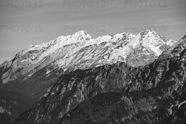 View of the summits of Hochkalter on the left and Hocheisspitze on the right in the Berchtesgaden Alps with fresh snow in autumn, black and white, Berchtesgaden National Park, Bavaria and Austria