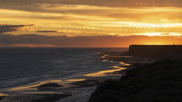 Sunset on the Atlantic coast of Patagonia at Balneario El Condor with the largest parrot colony in the world, Rio Negro province, Argentina