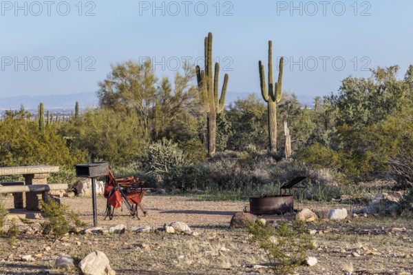 Camping chairs at a desert campsite at the White Tank Mountain Regional Park campground in Phoenix, Arizona, USA