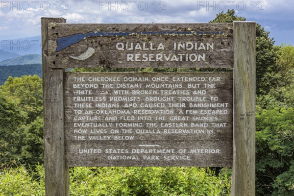 Sign along the Blue Ridge Parkway tells the origin of the Qualla Indian Reservation in the Smoky Mountains near Cherokee, North Carolina, USA