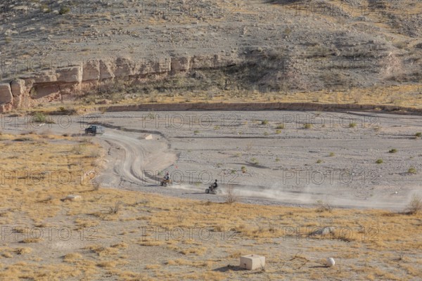 People riding all terrain vehicles through Echo Wash at Echo Bay, Nevada, USA