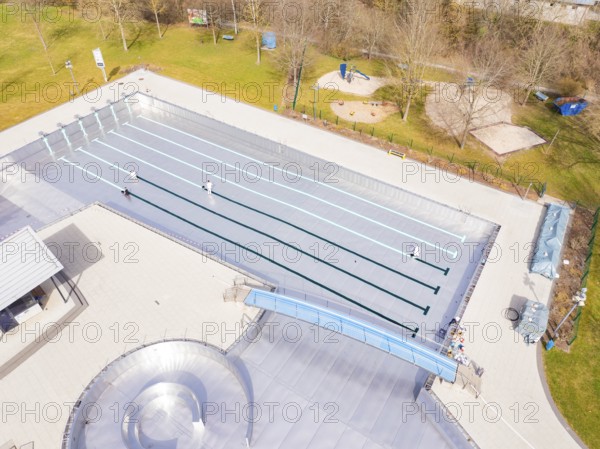 Aerial view of an empty outdoor pool with swimming pool and surrounding lawn in autumnal atmosphere, renewal of the swimming lines, Calw Stammheim outdoor pool, Calw, Black Forest, Germany