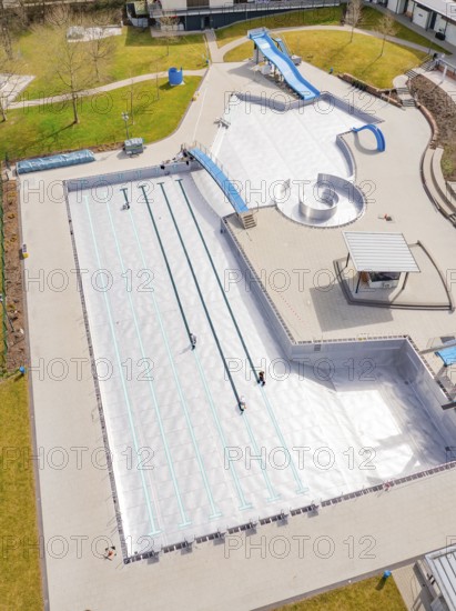 Focus on part of the swimming area with water slides and adjacent walkways, renewal of the swimming lines, Calw Stammheim outdoor pool, Calw, Black Forest, Germany