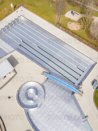 Aerial view of an empty swimming pool with a small playground nearby, renovation of the swimming lines, Calw Stammheim outdoor pool, Calw, Black Forest, Germany