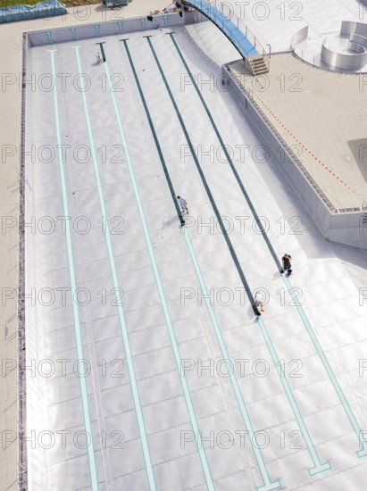 Close-up of the swimming lanes with three people in the empty pool area, renovation of the swimming lines, Calw Stammheim outdoor pool, Calw, Black Forest, Germany